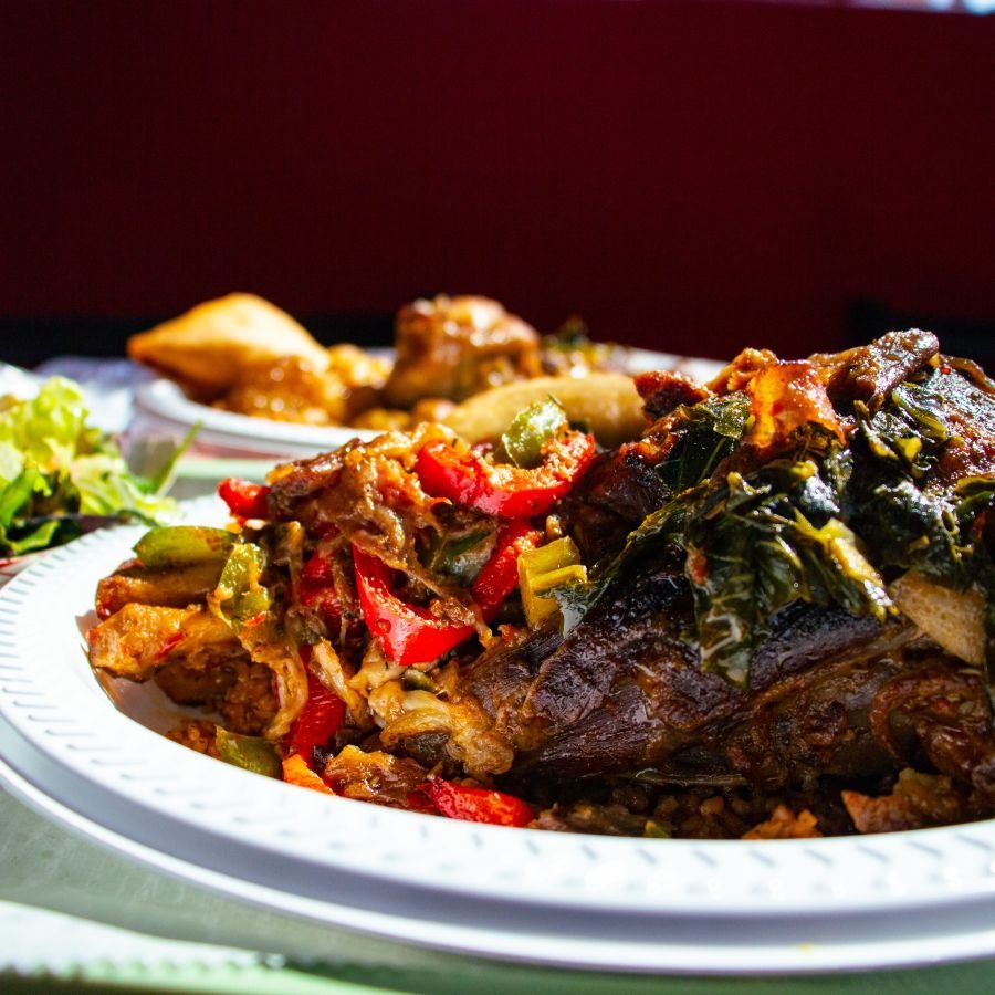 Braised lamb and vegetable platter with peppers and greens
