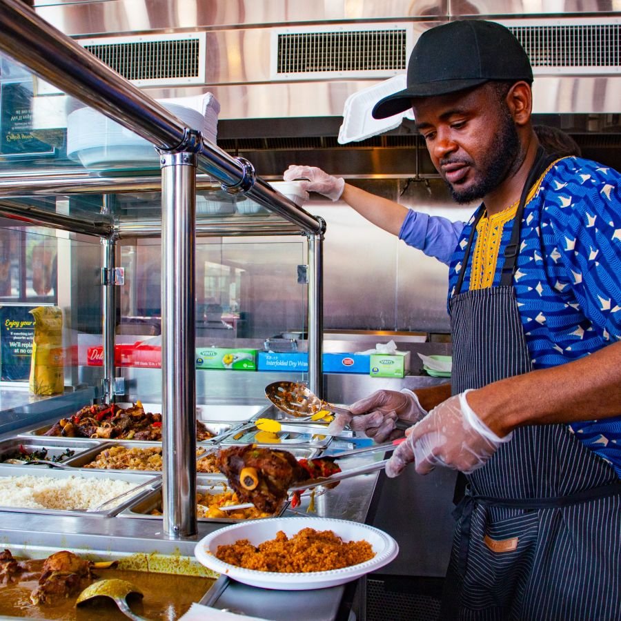 Chef plating a meal at Teranga Grill
